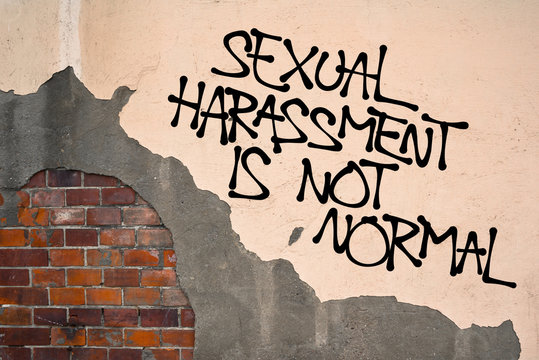 Sexual Harassment Is Not Normal - Handwritten graffiti sprayed on wall, anarchist aesthetics - appeal to resist and fight against sexually offensive behavior and verbal or physical assault