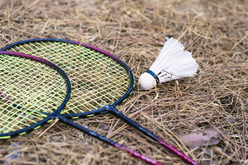 one shuttlecock and badminton rackets