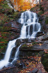 Fototapeta na wymiar rocky Waterfall in Autumn forest
