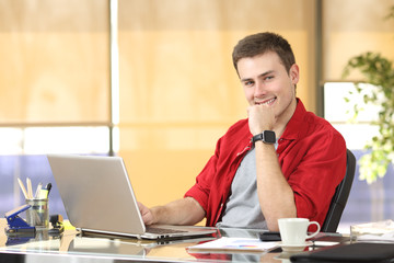 Entrepreneur working at office looking at you