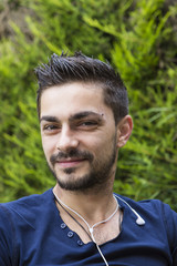 Young man with earphones outdoors