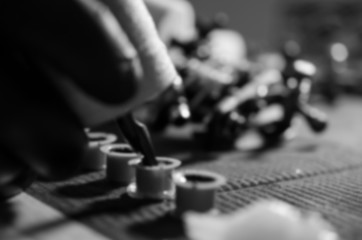 Defocused image of tattoo artist picking a color.