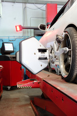 Car on a lift in a car repair station 