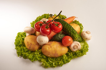 mushrooms, potatoes, cucumber, tomatoes on lettuce leaves