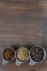 Different types of coffee on a wooden background