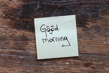 Message Good morning with smiley face on wooden table