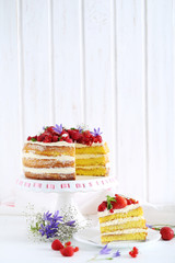 Delicious biscuit cake with berries on cake stand
