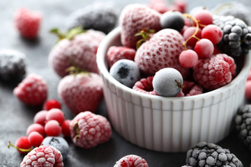 Frozen berries on a black wooden table