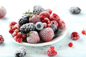 Frozen berries on a white wooden table