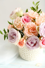 Bouquet of beautiful roses on a blue wooden table