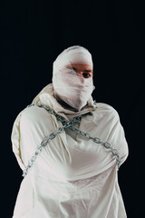 Patient in straitjacket and chains