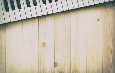 Music Keyboard on wooden texture table for background with copy space.