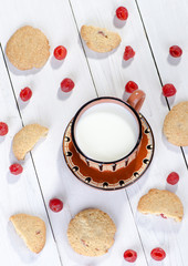 Milk with cookies and cherry, top view
