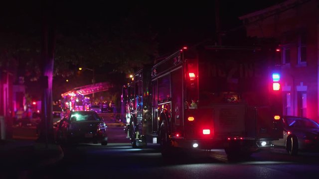 fire truck on residential street at night. all markings removed.