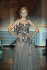 Fototapeta premium Attractive fashion model on stage in soffit lights. Wedding makeup and hair style.