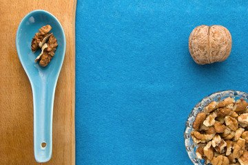 Walnuts. Top view of wooden Board and blue background. For kitchen and menu 