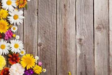 Garden flowers over wooden background
