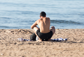 Fototapeta na wymiar a man in a bathing suit on the beach