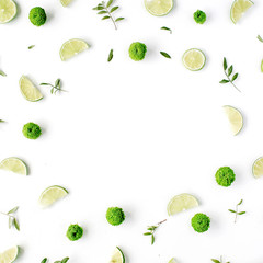 lime and green branches frame on white background. flat lay, top view