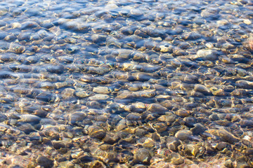 stones under the surface of the water in nature
