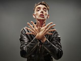Emotional portrait of a teenager dancing on a gray background