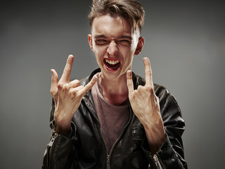Emotional portrait of a teenager dancing on a gray background