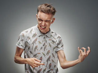 Emotional portrait of a teenager on a gray background