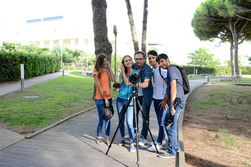 group of young photography students with teacher during outdoor photo course