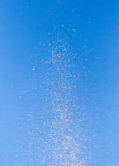 Fototapeta na wymiar water splashing from the fountain in the background of blue sky