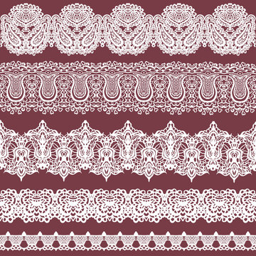 Set of white lace borders isolated on brown background