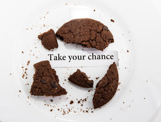 Brown Oatmeal cookie with future prediction note saying take your chance