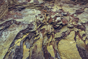 Ferruginous rock strata closeup. Rock layers background.