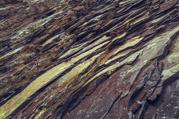 Ferric rock strata closeup. Rusty rock pattern.