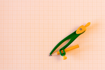 Pair of compasses on graph paper.