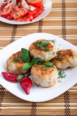 Chicken meatballs and a salad of raw tomatoes
