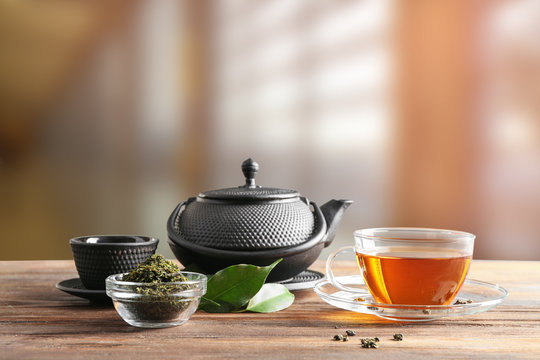 Tea set on wooden table and blurred background