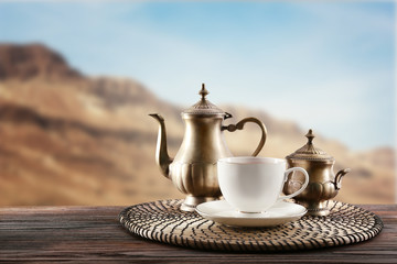 Vintage tea set on wooden table and blurred nature background