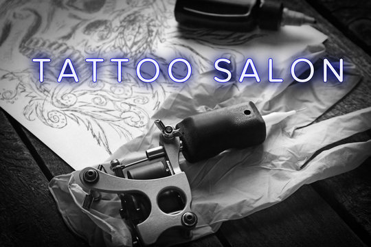 Workplace of tattoo master with text Tattoo Salon