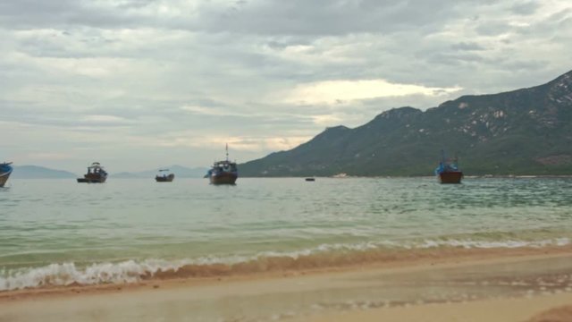 Sand Beach Wave Surf Small Boats in Azure Sea Bay in Vietnam