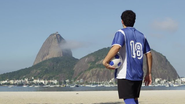 Soccer player looks at Rio de Janiero and Sugarloaf mountain