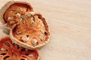 Dry Bael Fruit tea (Aegle marmelos) on wooden table