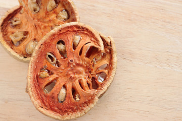Dry Bael Fruit tea (Aegle marmelos) on wooden table