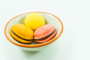 Candy came to be placed in a cup on a white background.