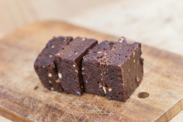 Fototapeta na wymiar Homemade chocolate brownies over wooden background