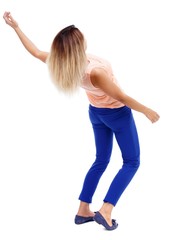 Balancing young woman. or dodge falling woman. Isolated over white background. The blonde in a pink t-shirt curved back.