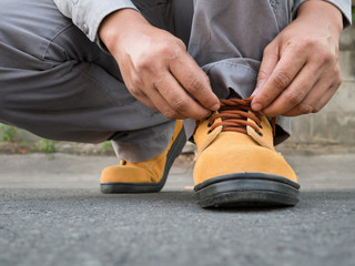 Man wears safety shoes on street