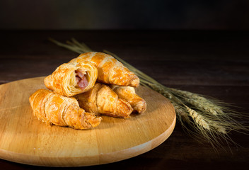 Ham and cheese croissant on cutting board