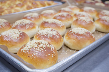 Obraz na płótnie Canvas Bread baked with white sesame on aluminium oven tray