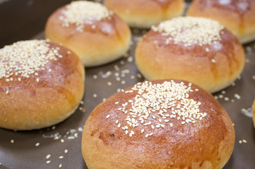 Obraz na płótnie Canvas Brown bread baked with white sesame on oven tray
