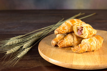 Ham and cheese croissant on cutting board